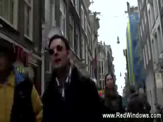 Host takes a turist on a tour of the red light district